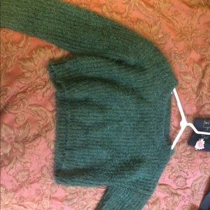 Green knitted sweater.